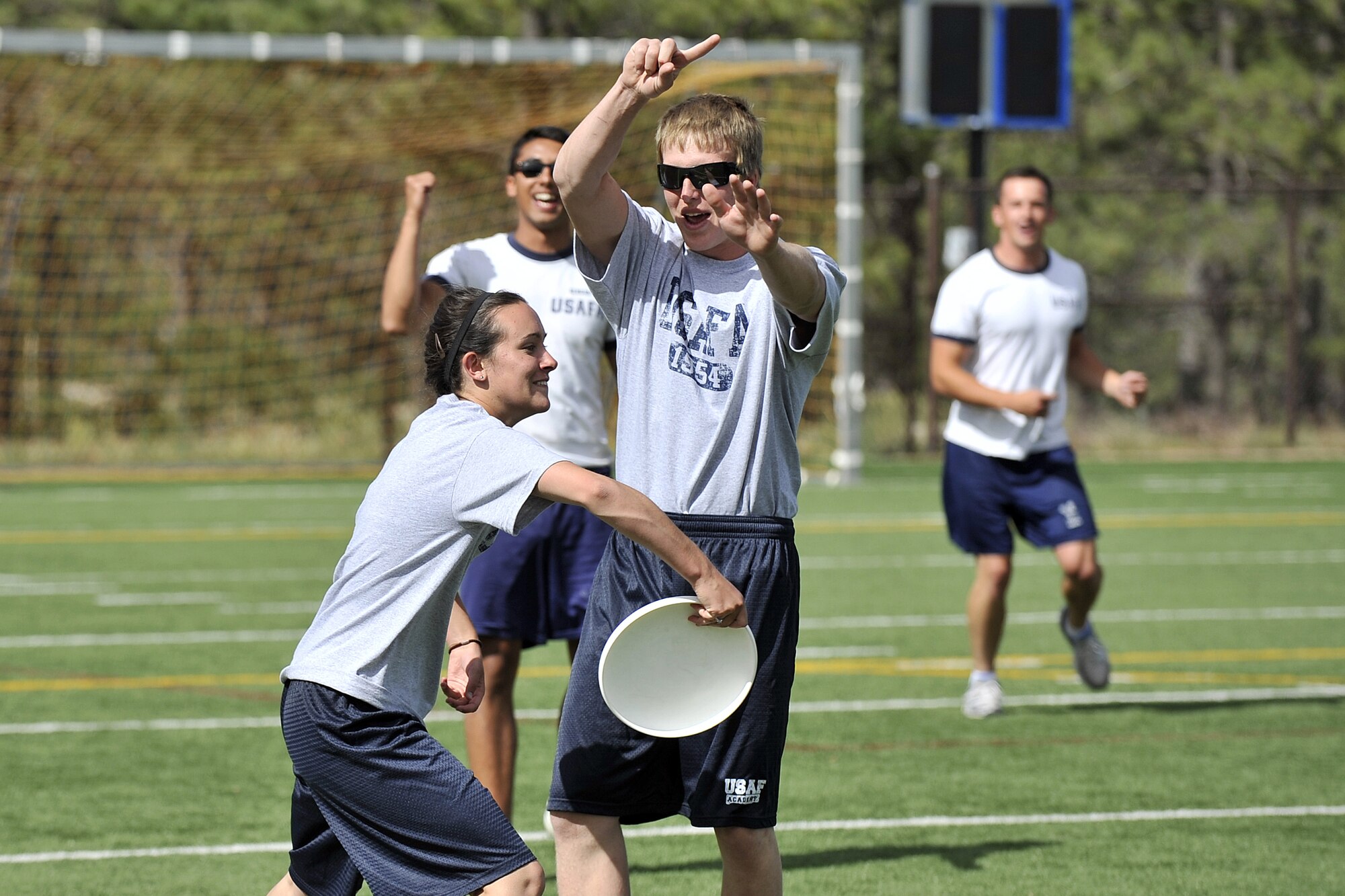 High school junior Heather Nereson (left)  and senior Ryan Domson (right)  play ultimate Frisbee with high school and cadet participants at Character Camp 2012.
(U.S. Air Force Photo/Raymond McCoy)