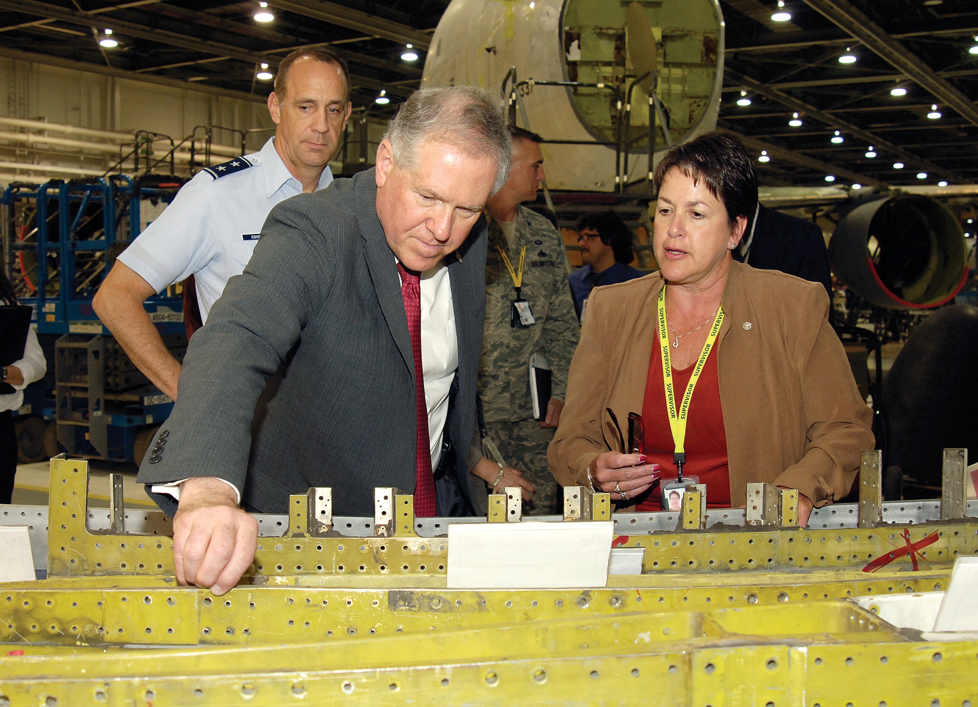 Frank Kendall, the under secretary of Defense for Acquisition, Technology and Logistics at the Pentagon, gets a feel of the corrosion faced by Tinker KC-135 mechanics, outlined by Theresa Farris, director of the 564th Aircraft Maintenance Squadron.  During his June 5 Tinker visit, Mr. Kendall toured maintenance areas in Bldgs. 9001 and 3001 and learned of the base’s successes and preparation for new workloads.  Also touring Tinker with Mr. Kendall was Maj. Gen. John Cooper, director of Logistics, Deputy Chief of Staff for Logistics, Installations and Mission Support. (Air Force photo by Margo Wright)