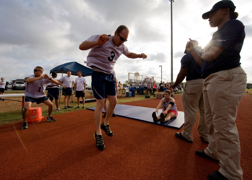 Participants in the Dyess Warrior Challenge perform squats, burpees and sit-ups June 20, 2012, at Dyess Air Force Base, Texas. The challenge consisted of teams and individual competitors who completed a variety of exercises while being timed. Teams of four completed squats, burpees and sit-ups together, and ran two miles as a pack. Individual participants completed two 400-meter laps, sit-ups, push-ups, burpees and a water jug carry. (U.S. Air Force graphic by Airman 1st Class Damon Kasberg/Released)