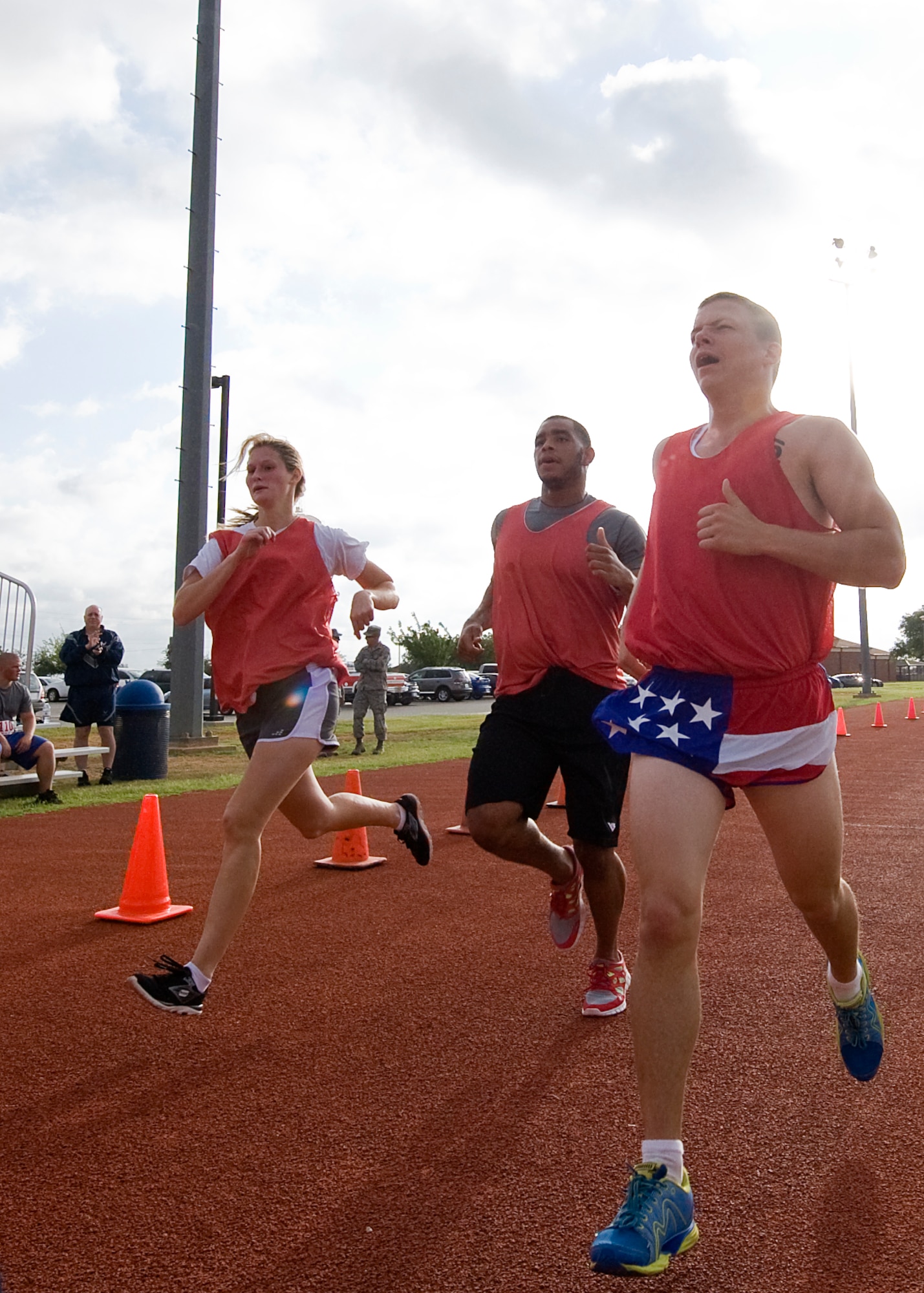 Participants in the Dyess Warrior Challenge finish a two-mile run June 20, 2012, at Dyess Air Force Base, Texas. The challenge consisted of individual and team events. Teams of four completed a variety of exercises together, and ran two miles as a pack, while individuals completed two 400-meter laps, sit-ups, push-ups, burpees and a water jug carry. (U.S. Air Force graphic by Airman 1st Class Damon Kasberg/Released)