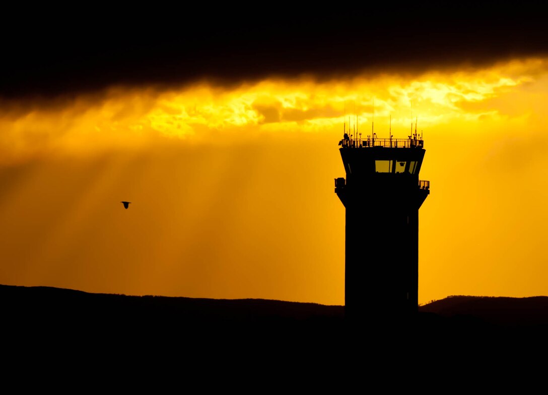Air traffic control operation specialists from the 28th Operations Support Squadron keep an eye on the horizon for approaching inclement weather as the sun sets on Ellsworth Air Force Base, S.D., June 18, 2012. ATC specialists safely manage the flow of traffic on and around the base flightline and in a 50,000 square-mile air space. (U.S. Air Force photo by Airman 1st Class Zachary Hada/Released)