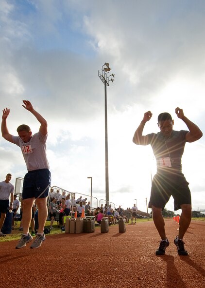Dyess servicemembers perform burpees June 20, 2012, during a Warrior Challenge at Dyess Air Force Base, Texas. The challenge consisted of team and individual competitors who completed a variety of exercises while being timed. Teams of four completed squats, burpees and sit-ups together, and ran two miles as a pack. Individual participants completed two 400-meter laps, sit-ups, push-ups, burpees and a water jug carry. (U.S. Air Force graphic by Airman 1st Class Damon Kasberg/Released)