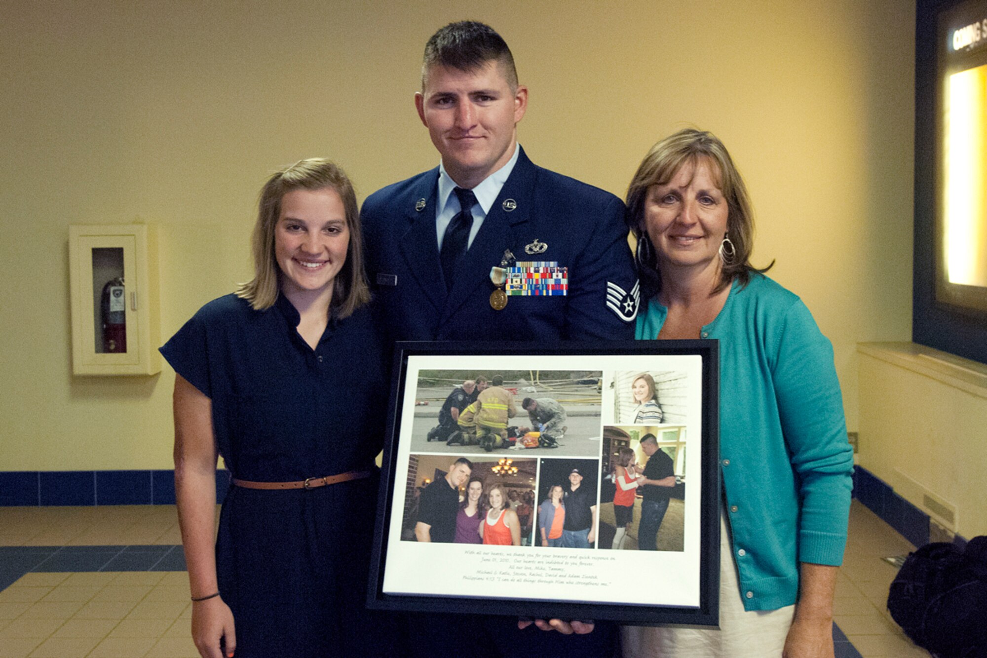 JOINT BASE ELMENDORF-RICHARDSON, Alaska -- Air Force Staff Sgt. Jacob Gibson poses with a gift he recieved from Rachel Zientek and her mother Tammy Zientek June 18,2012. Gibson rescued Rachel Zientek from the wreckage of a plane that day. (U.S. Air Force photo/Airman 1st Class Omari Bernard)
