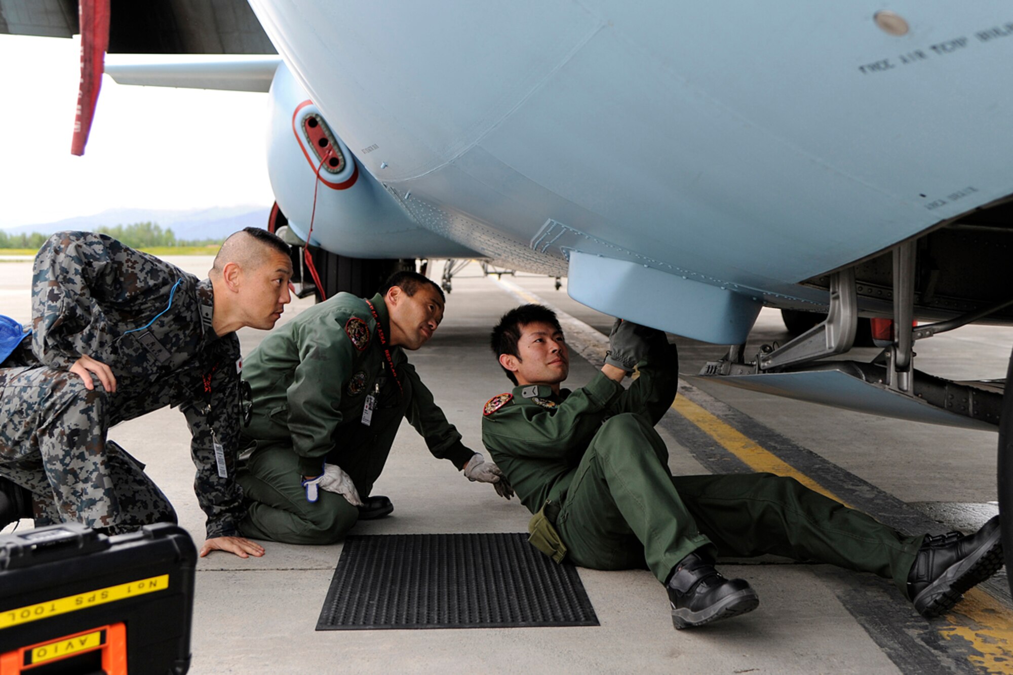 Members of the Japanese Air Self Defense Force work on a Japanese C-130 Hercules during Red Flag - Alaska on the flight line of Joint Base Elmendorf-Richardson, Alaska June 19. The C-130 Hercules offers a maximum speed of 600 kilometers an hour with a payload of 19,400 pounds and can be used for air drops. Red-Flag Alaska is designed to strengthen bilateral ties between nations and offers the JASDF the opportunity to improve aerial tactics. (U.S. Air Force photo/Staff Sgt. Zachary Wolf)