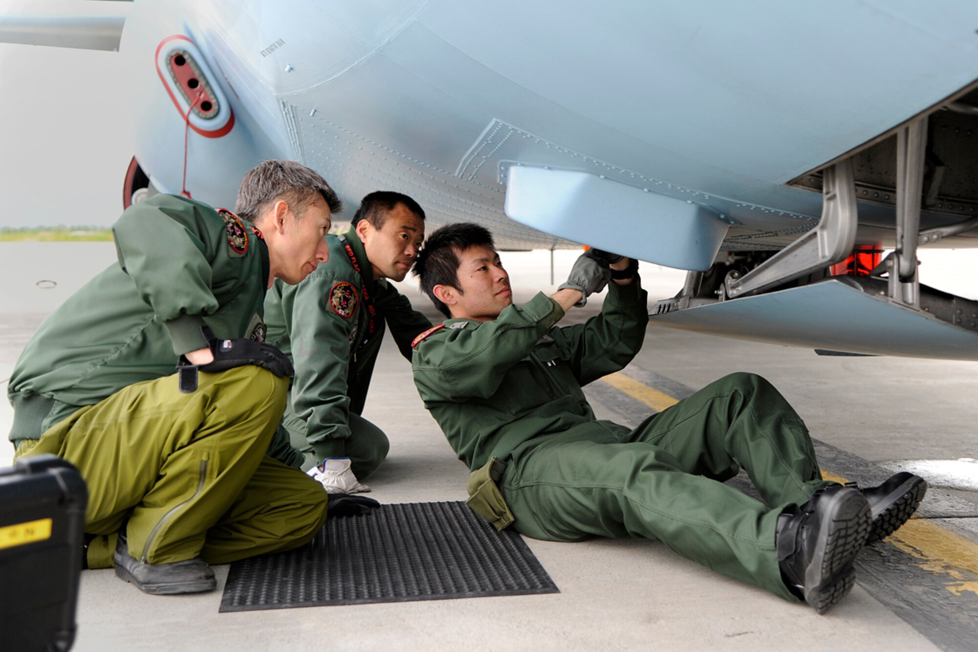 Members of the Japanese Air Self Defense Force work on a Japanese C-130 Hercules during Red Flag - Alaska on the flight line of Joint Base Elmendorf-Richardson, Alaska June 19. The C-130 Hercules offers a maximum speed of 600 kilometers an hour with a payload of 19,400 pounds and can be used for air drops. Red-Flag Alaska is designed to strengthen bilateral ties between nations and offers the JASDF the opportunity to improve aerial tactics. (U.S. Air Force photo/Staff Sgt. Zachary Wolf)