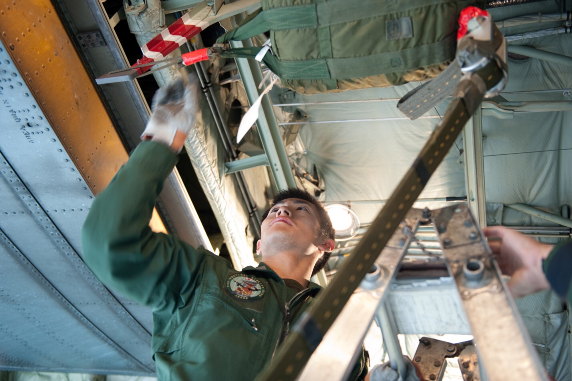 Japanese Air Self Defense Force Staff Sgt.Toshiyuki Sugimoto checks the air drop system during pre-flight inspections for the Japanese C-130 Hercules during Red Flag - Alaska on the flight line of Joint Base Elmendorf-Richardson, Alaska June 19. The C-130 Hercules offers a maximum speed of 600 kilometers an hour with a payload of 19,400 pounds and can be used for air drops. Red-Flag Alaska is designed to strengthen bilateral ties between nations and offers the JASDF the opportunity to improve aerial tactics. (U.S. Air Force photo/Staff Sgt. Robert Barnett)