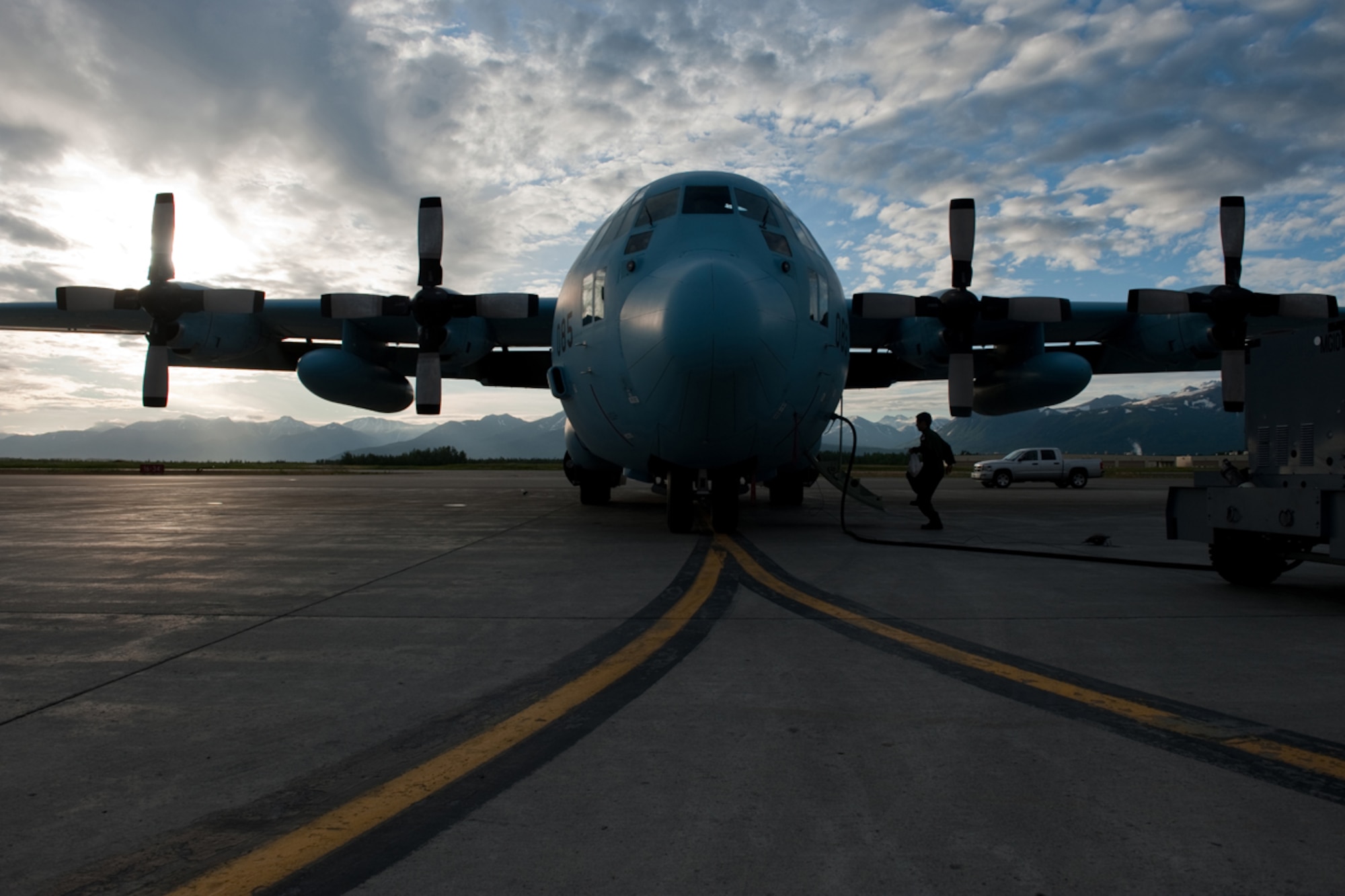 A member of the Japanese Air Self Defense Force performs pre-flight inspections while the Japanese C-130 Hercules recharges during Red Flag - Alaska on the flight line of Joint Base Elmendorf-Richardson, Alaska June 19. The C-130 Hercules offers a maximum speed of 600 kilometers an hour with a payload of 19,400 pounds and can be used for air drops. Red-Flag Alaska is designed to strengthen bilateral ties between nations and offers the JASDF the opportunity to improve aerial tactics. (U.S. Air Force photo/Staff Sgt. Robert Barnett)