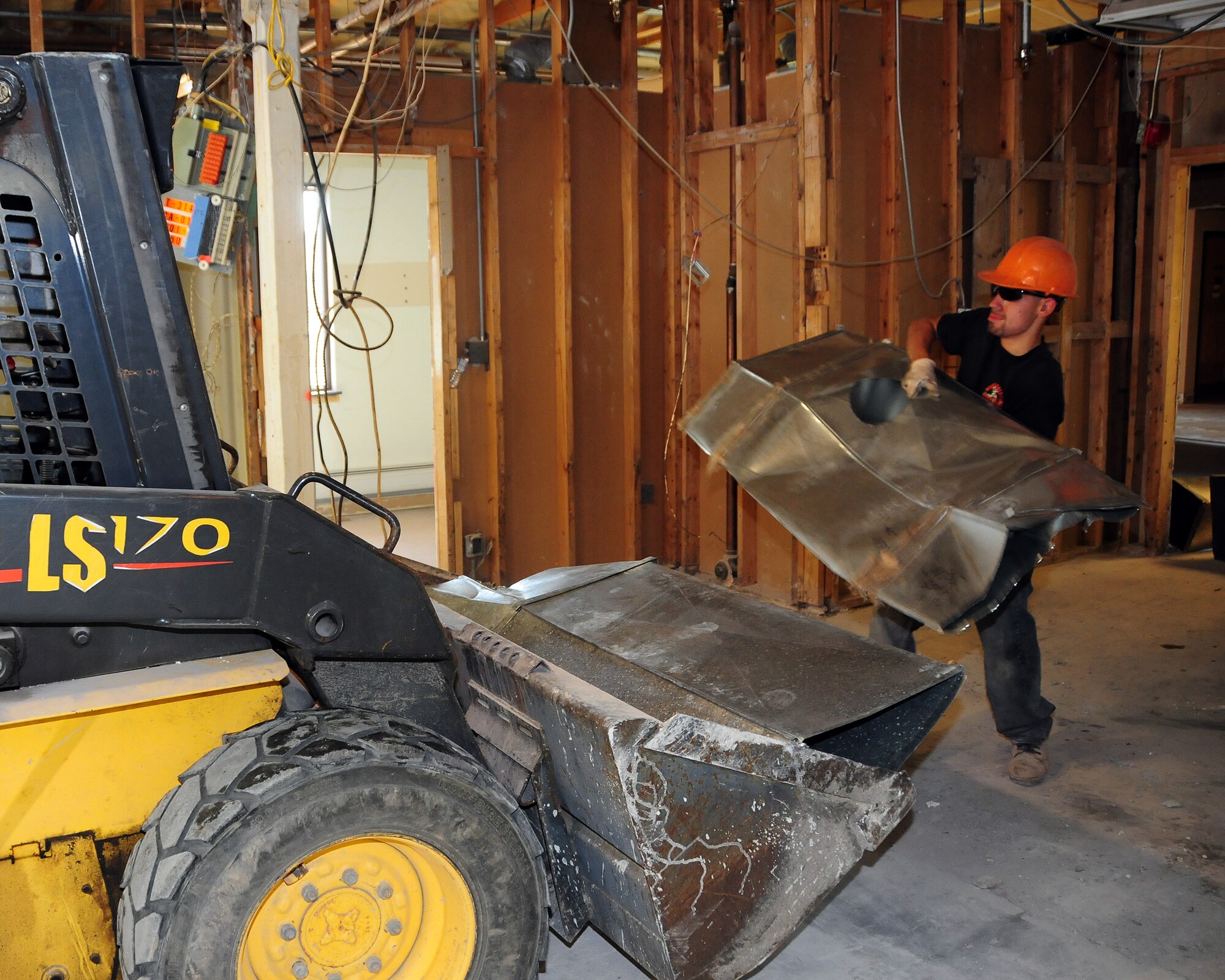 A construction worker removes old ductwork to be recycled from the old Falcon Club on June 20, 2012 at the Niagara Falls Air Reserve Station, New York. The former all ranks club is currently being renovated to provide space for several 914th Force Support Squadron, Sustainment Services Flight, sections. The Sustainment Services Flight is temporarily operating out of a pre-WWII building that is slated for demolition upon completion of renovations.  Construction is expected to be completed in mid October of this year. (U.S. Air Force photo by Peter Borys)