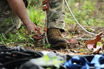 U.S. Air Force Tech. Sgt. Daniel Daubert, 347th Operations Support Squadron survival, evasion, resistance and escape specialist, dons tree-climbing spurs prior to ascending a pine tree during a tree rescue course at Moody Air Force Base, Ga., June 11, 2012. The spiked spurs allow the climber to ascend a tree while using a rope and harness for stability and safety. (U.S. Air Force photo by Master Sgt. Sonny Cohrs/Released)
