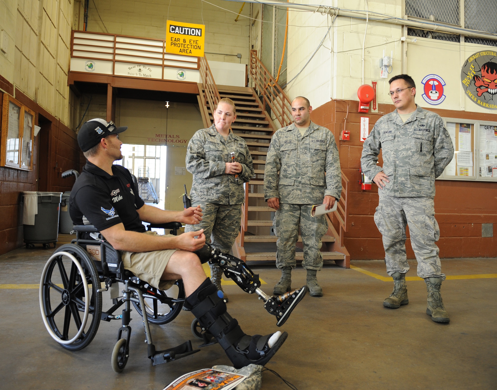 Mike Schultz, a MotoX dirt bike and SnoX snowmobile racer who lost his left leg after an accident, speaks with members of the 2nd Maintenance Squadron metals technology shop on Barksdale Air Force Base, La., June 20. Schultz is touring with Robi Powers, American300 tour founder, at Air Force Global Strike Command bases to talk about his story and motivate Airmen to go out and do something active. (U.S. Air Force photo/Airman 1st Class Benjamin Gonsier)(RELEASED)
