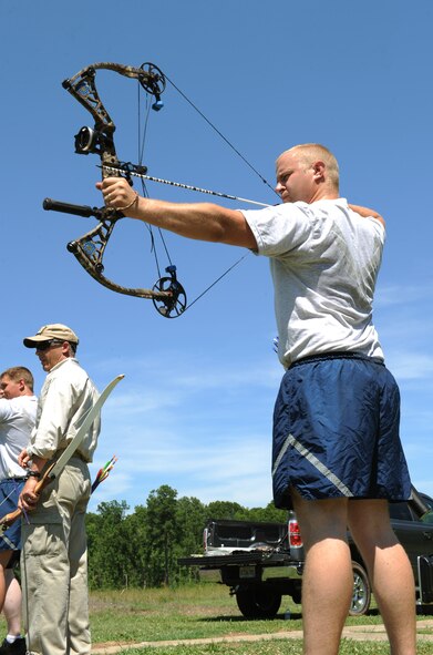 Staff Sgt. Chad Bogaczyk, 2nd Security Forces combat arms instructor, aims his bow and arrow at a target as Robi Powers, American300 founder, watches on Barksdale Air Force Base, La., June 20. Bogaczyk is an avid fisherman and hunter who participates in many outdoor activities in his free time. Powers is touring Air Force Global Strike Command bases with Mike Schultz, a MotoX dirt bike and SnoX snowmobile racer who lost his left leg after an accident, to talk to and motivate Airmen to go out and do something active in the summer. (U.S. Air Force photo/Airman 1st Class Benjamin Gonsier)(RELEASED)