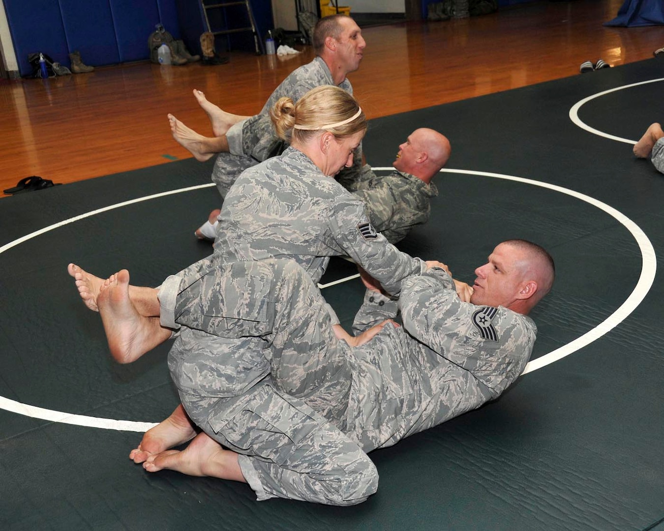 Staff Sgt. Elbert Fish, military training instructor with the 321st Training Squadron, fights off Staff Sgt. Jesse Armstrong's attempt at a cross collar choke during combatives training June 12 at the Warhawk Fitness Center. Armstrong is a security forces technical training instructor with the 343rd TRS. (U.S. Air Force photo/Alan Boedeker)