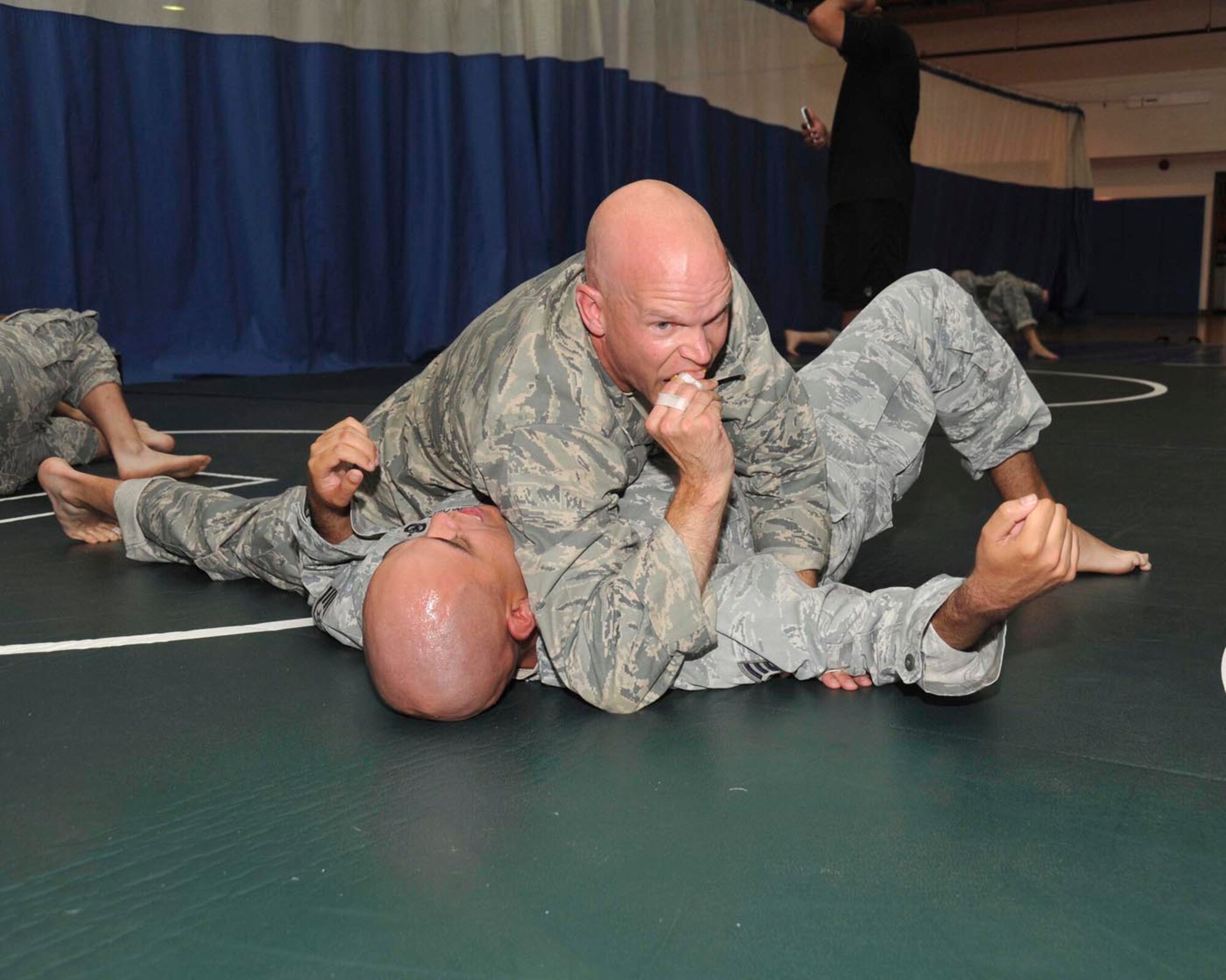 Lt. Col. Tim Thurston, 322nd Training Squadron commander, attempts to pin Staff Sgt. Mark Velasquez, a security forces technical training instructor with the 343rd TRS, during a grappling drill June 12 at the Warhawk Fitness Center. Soldiers from Army III Corps, Fort Hood, Texas, were here last week to teach the Modern Army Combatives Program course to instructors from Air Force Basic Military Training and the security forces technical training school. (U.S. Air Force photo/Alan Boedeker)
