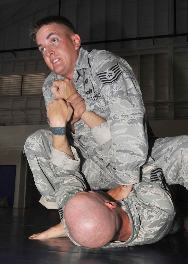 Tech Sgt. Daniel Duhaime staves off Tech. Sgt. Jason Dearinger's attempt at setting up an arm bar from mount during combatives training June 12 at the Warhawk Fitness Center. Both NCOs are members of the cadre staff at the Basic Expeditionary Airman Skills Training complex. (U.S. Air Force photo/Alan Boedeker)