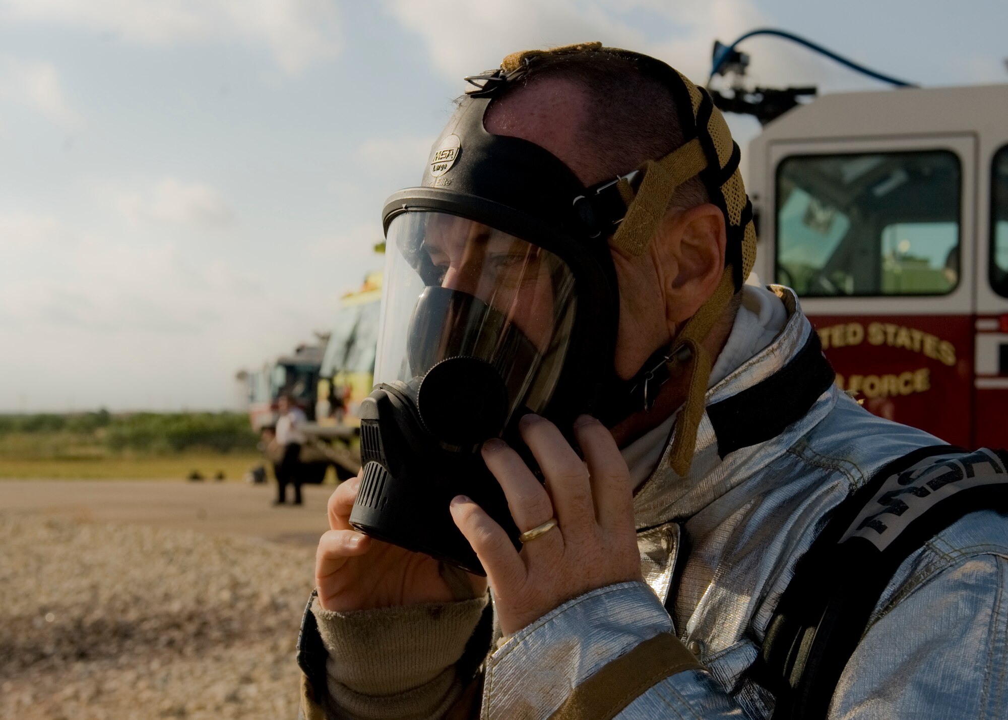 U.S. Air Force Col. David Béen, 7th Bomb Wing commander, suits up in bunker gear June 20, 2012, at the Fire Department training grounds on Dyess Air Force Base, Texas. Base leadership experienced firefighting from a firefighters point of view. Training started with an exterior Jet Propellant 8 explosion, followed by an interior propane explosion in the cockpit to demonstrate the difference between the two fuel types. Firefighters are responsible for protecting Air Force assets in case of fire. Dyess’ Fire Department training grounds enable airmen to qualify on both propane and jet fuel. (U.S. Air Force photo by Airman 1st Class Peter Thompson/ Released)