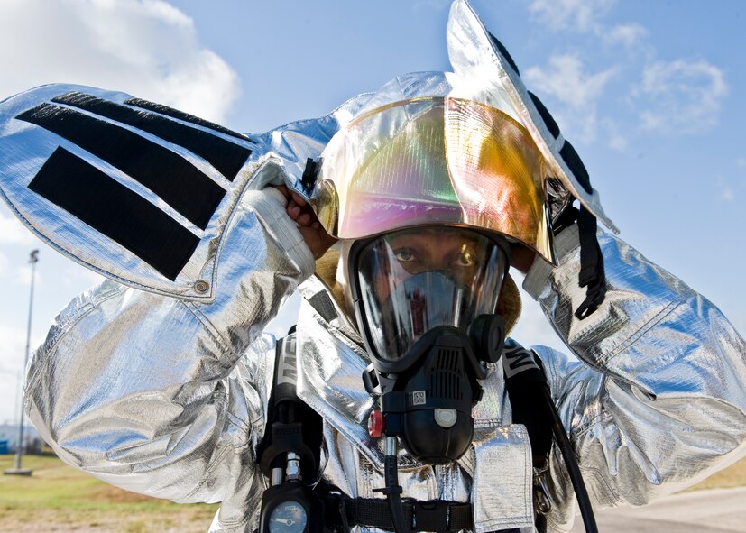 Chief Master Sgt. Kenneth Lindsey, 7th Bomb Wing command chief, suits up in bunker gear June 20, 2012, at the Fire Department training grounds on Dyess Air Force Base, Texas. Base leadership experienced firefighting from a firefighters point of view. Training started with an exterior Jet Propellant 8 explosion, followed by an interior propane explosion in the cockpit to demonstrate the difference between the two fuel types. Firefighters are responsible for protecting Air Force assets in case of fire. Dyess’ Fire Department training grounds enable airmen to qualify on both propane and jet fuel. (U.S. Air Force photo by Airman 1st Class Peter Thompson/ Released)