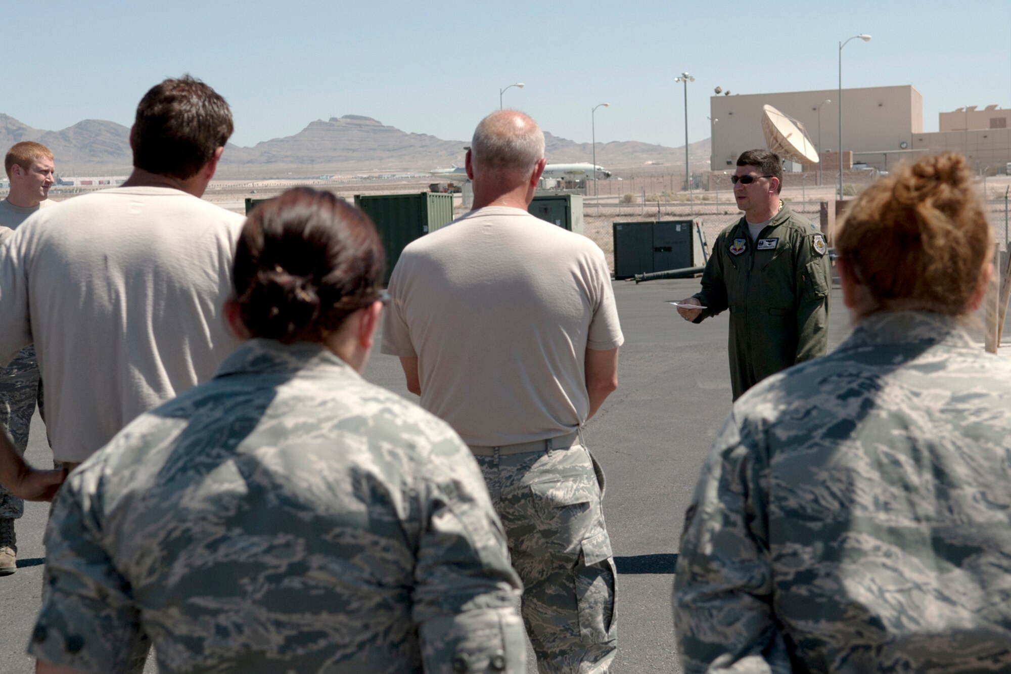 U.S. Air Force Lt. Col. Kurt Schendzielos, 340th Weapons Squadron commander, congratulates a group of Airmen on their accomplishments following the launch of the last B-52 bomber sortie in support of a Mission Employment exercise, Nellis Air Force Base, Nev., June 12, 2012. Personnel from 307th and 2nd Bomb Wings from Barksdale AFB, La., generated 14 B-52 sorties for a 100 percent mission success rate, and six B-52 aircrew members graduated from the United States Air Force Weapons School. (U.S. Air Force photo by Master Sgt. Greg Steele/Released)