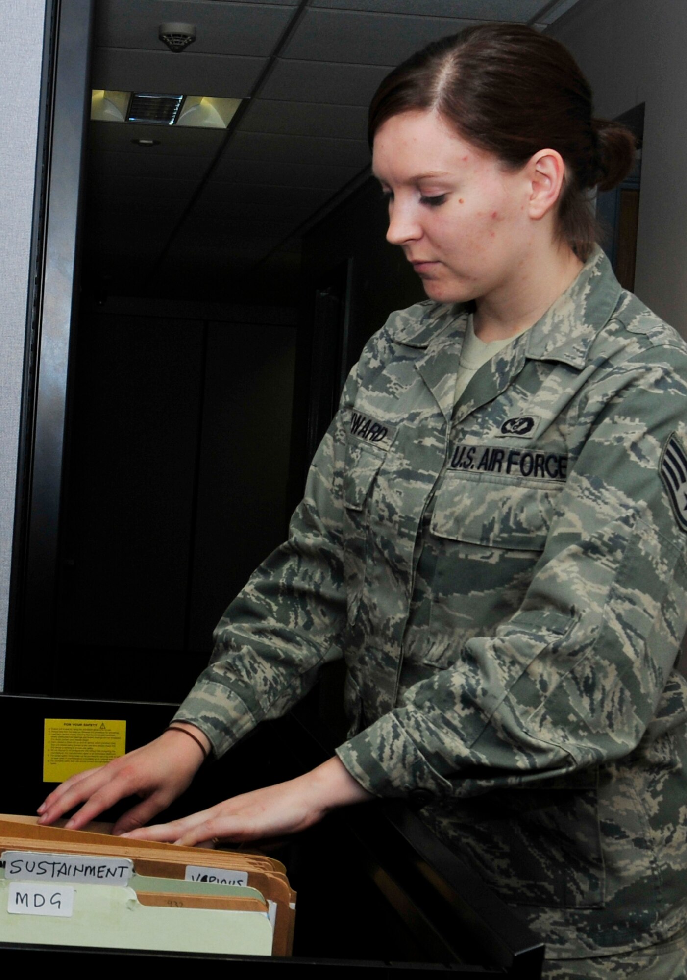 ROYAL AIR FORCE LAKENHEATH, England - Staff Sgt. Tracy Hayward, 48th Civil Engineer Squadron operations management craftsman, sorts through files at the 48th CES Customer Service building June 22, 2012. Hayward was nominated for a Liberty Spotlight because she displays the core value of "Excellence in All We Do." (U.S. Air Force photo by Senior Airman Tiffany M. Deuel)