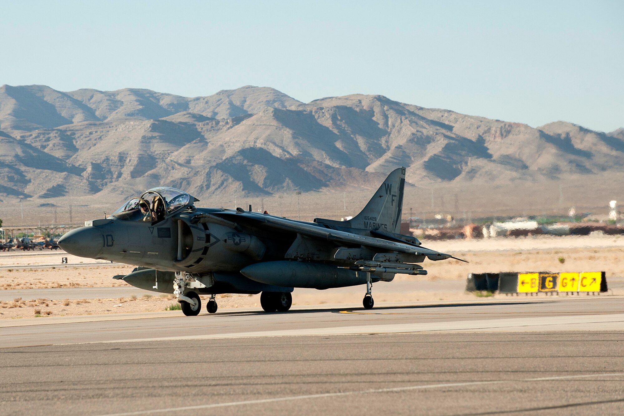 A U.S. Marine Corps AV-8 Harrier II taxis down the flight line after returning from a sortie in support of a Mission Employment exercise, Nellis Air Force Base, Nev., June 12, 2012. The ME is a joint exercise incorporating all the services and dominating the battle space in the four contested domains of air, space, cyber and land. (U.S. Air Force photo by Master Sgt. Greg Steele/Released)