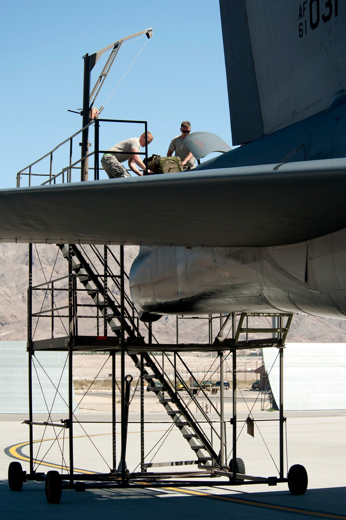 Maintenance personnel install a drag chute in the tail section of a B-52H Stratofortress after its return from a sortie in support of a Mission Employment exercise, Nellis Air Force Base, Nev., June 10, 2012. The ME is the capstone graduation exercise for soon to be Weapons Officers. (U.S. Air Force photo by Master Sgt. Greg Steele/Released)