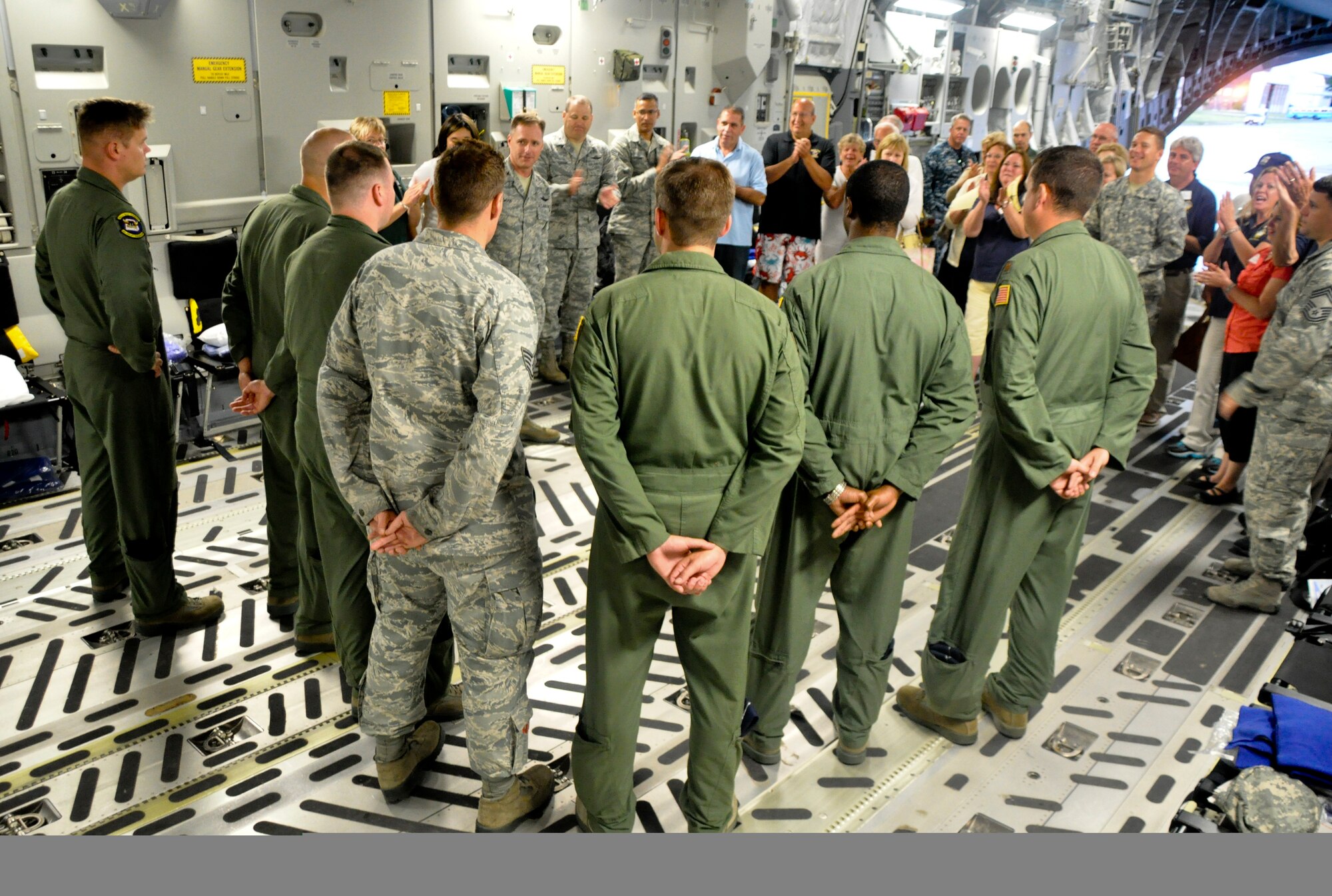 Col. John M. Wood, Joint Base McGuire-Dix-Lakehurst commander, addresses joint base leadership and civic leaders from the tri-state after returning here June 15 on a C-17 Globemaster III from a two-day community relations tour. The group toured Little Rock Air Force Base, Ark., and Joint Base San Antonio, Texas. (U.S. Air Force photo by 2nd Lt. David J. Murphy/Released)