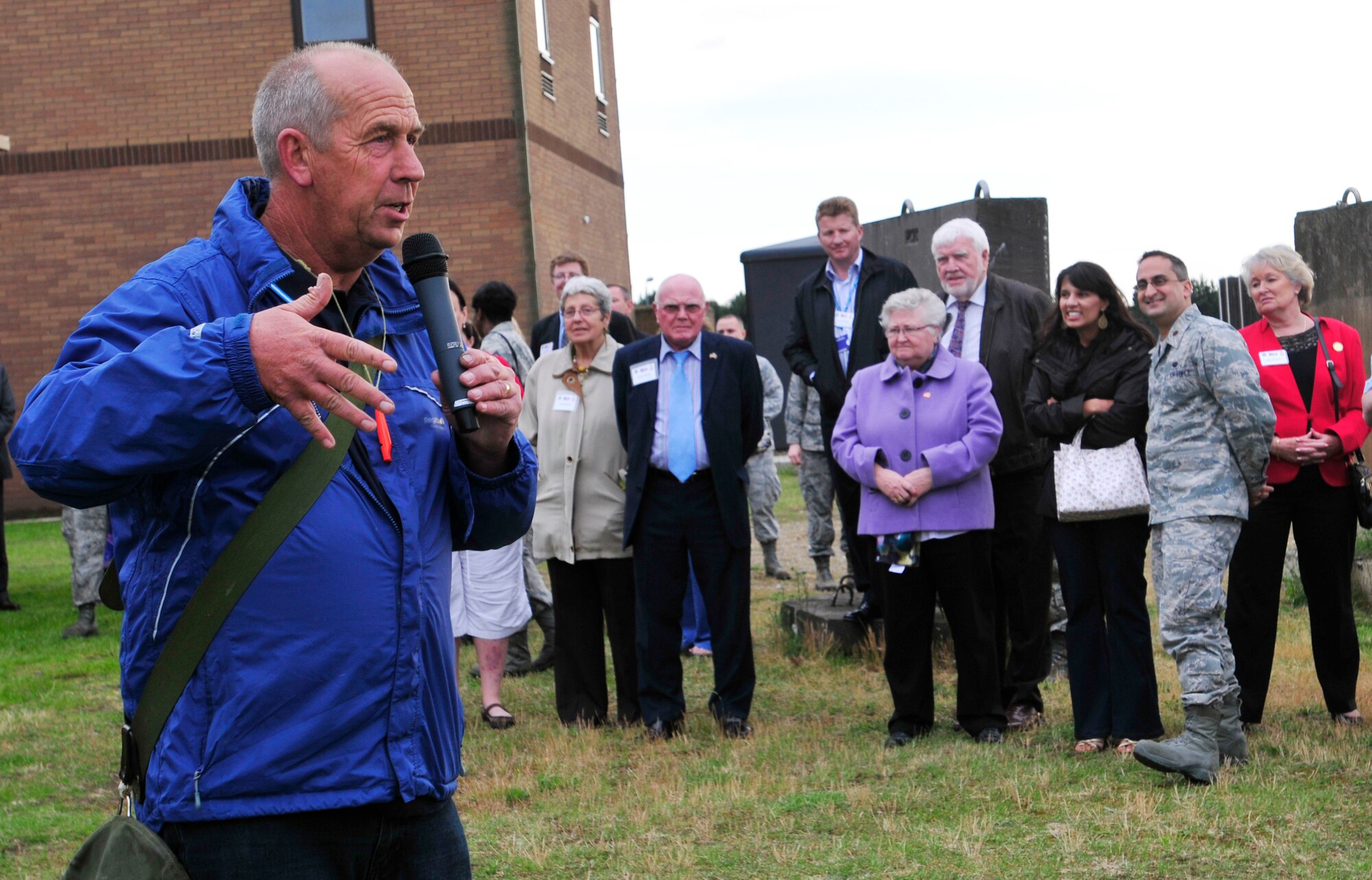 ROYAL AIR FORCE LAKENHEATH, England - Keith Mutton, Phoenix Bird Control falconer, speaks to Airmen, civilians and local British leaders during a birds of prey demonstration at the summer reception by the air traffic control tower, June 22, 2012. The visitors, including three new honorary commanders, witnessed a birds of prey demonstration and toured the air traffic control tower among other activities during the reception. (U.S. Air Force photo by Senior Airman Tiffany M. Deuel)