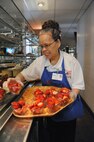 Loc Green, mess attendant, places fresh strawberries on the fruit display for lunch hour at Joint Base San Antonio-Randolph Rendezvous Dining Facility June 21. ( U S Air Force Photo by Don Lindsey)