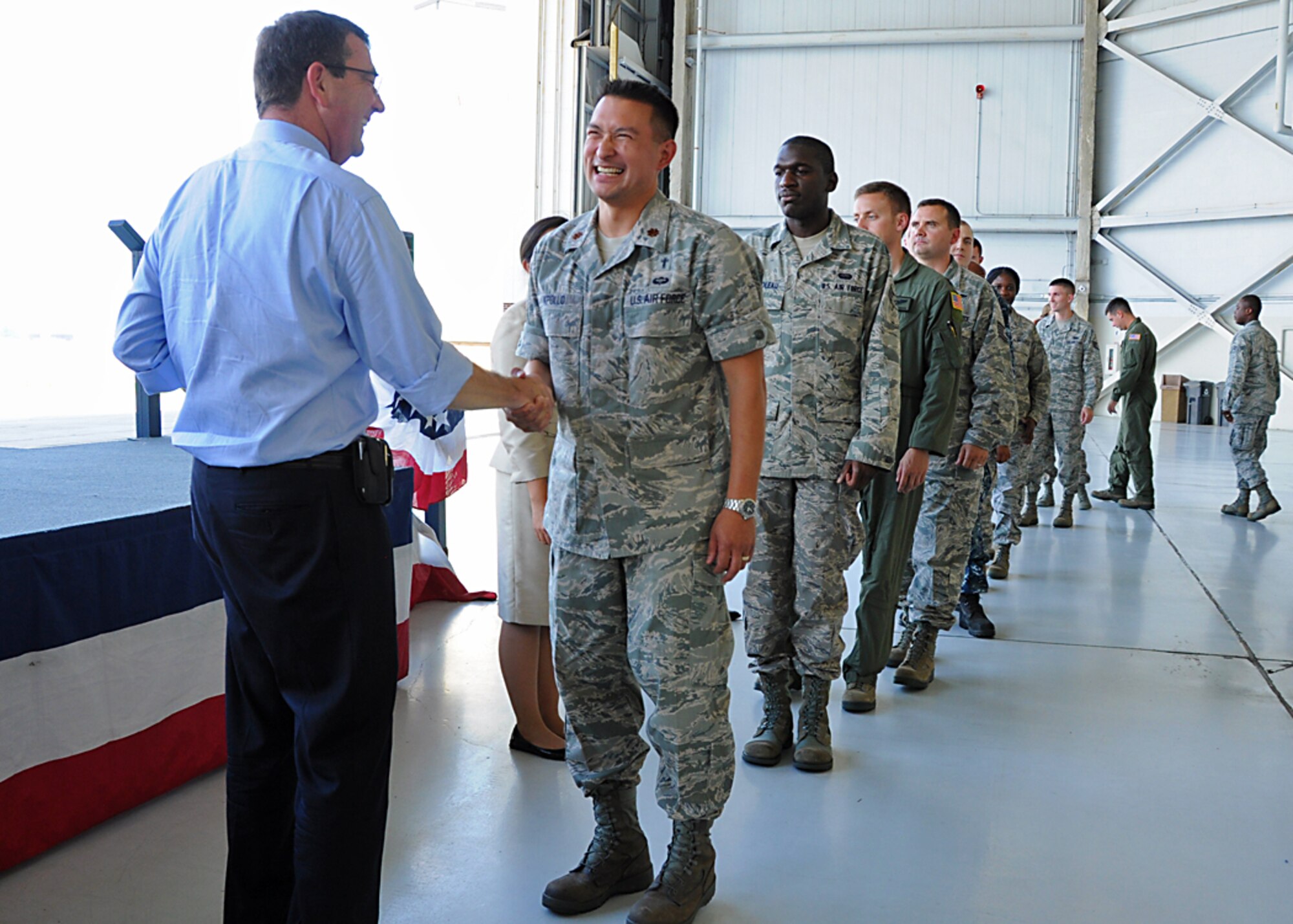 During a visit to Joint Base Charleston, S.C. June 18, Deputy Defense Secretary Ashton Carter recognized outstanding servicemembers by presenting them with his coin. Here he congratulates Chaplatin (Maj.) Ron Apollo, 315th Airlift Wing Chaplain Service. (U.S. Photo by Staff Sgt. Shane Ellis)