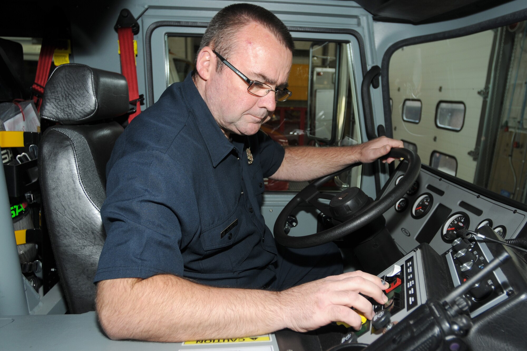 RAF FAIRFORD, United Kingdom - Robert McEvoy does routine checks on a fire engine here June 10. He was recently recognized as the Air Force Robert A. McAllister Heroism Award winner. The award recognizes acts of courage above and beyond the call of duty. (U.S. Air Force photo by Senior Airman Joel Mease)