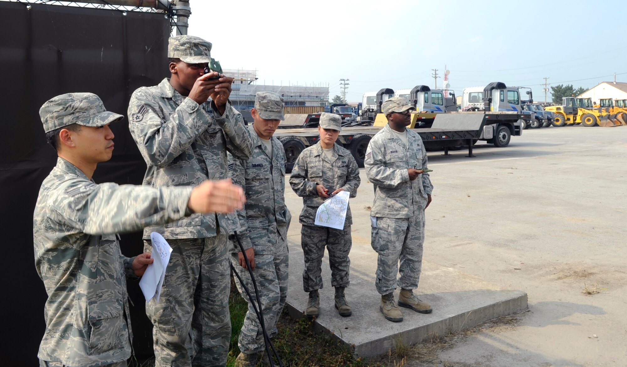 Staff Sgt. Kevin Kang, 8th Civil Engineer Squadron geobase technician, teaches fellow Red Devils to find a location using plotted coordinates during land navigation training June 21, 2012, at Kunsan Air Base, Republic of Korea. Kang has been learning and teaching about mapping for eight years. (U.S. Air Force photo/Senior Airman Brigitte N. Brantley)