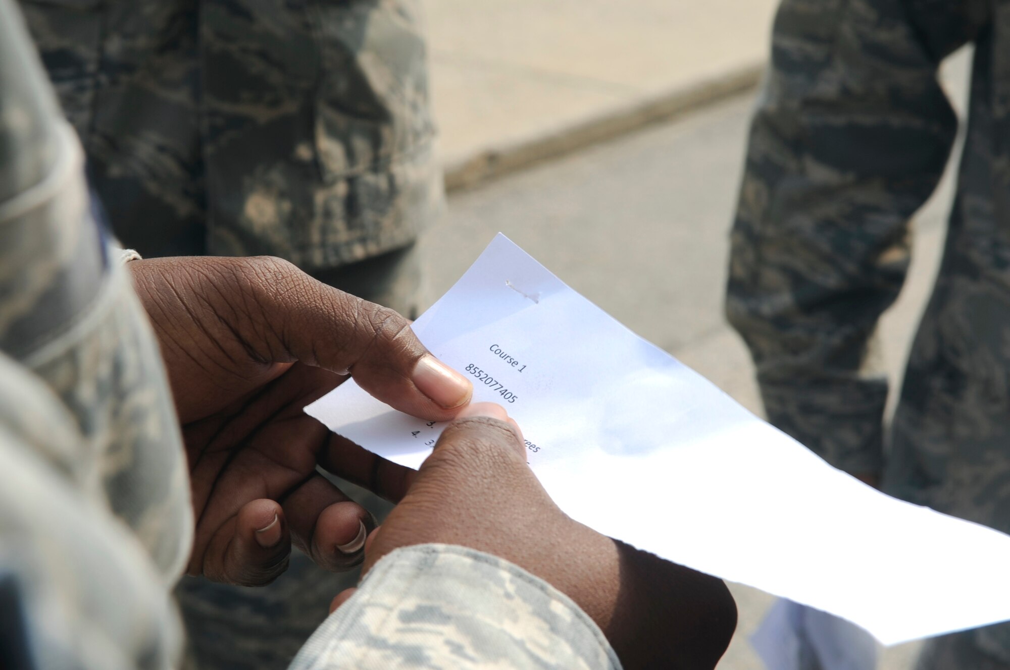 An Airman from the 8th Civil Engineer Squadron checks out coordinates before plotting them on a map during land navigation training June 21, 2012, at Kunsan Air Base, Republic of Korea. Being able to read coordinates comes in use during deployments and exercises. (U.S. Air Force photo/Senior Airman Brigitte N. Brantley)