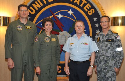 OFFUTT AIR FORCE BASE, Neb. - Air Commodore William Henman, Director General of Air Command Operations, Royal Australian Air Force, takes a photo with Brig. Gen. David Thompson, Deputy Director, Global Operations, U.S. Strategic Command; Maj. Gen. Susan Desjardins, Director, Plans and Policy, USSTRATCOM; and Capt. Stephen Elms, Australian Defence Force Liaison Officer, Royal Australian Navy, assigned to USSTRATCOM; during his visit to the command June 22, 2012.  AIRCDRE Henman received a command orientation and met with senior leadership. (Photo by Steve Cunningham)