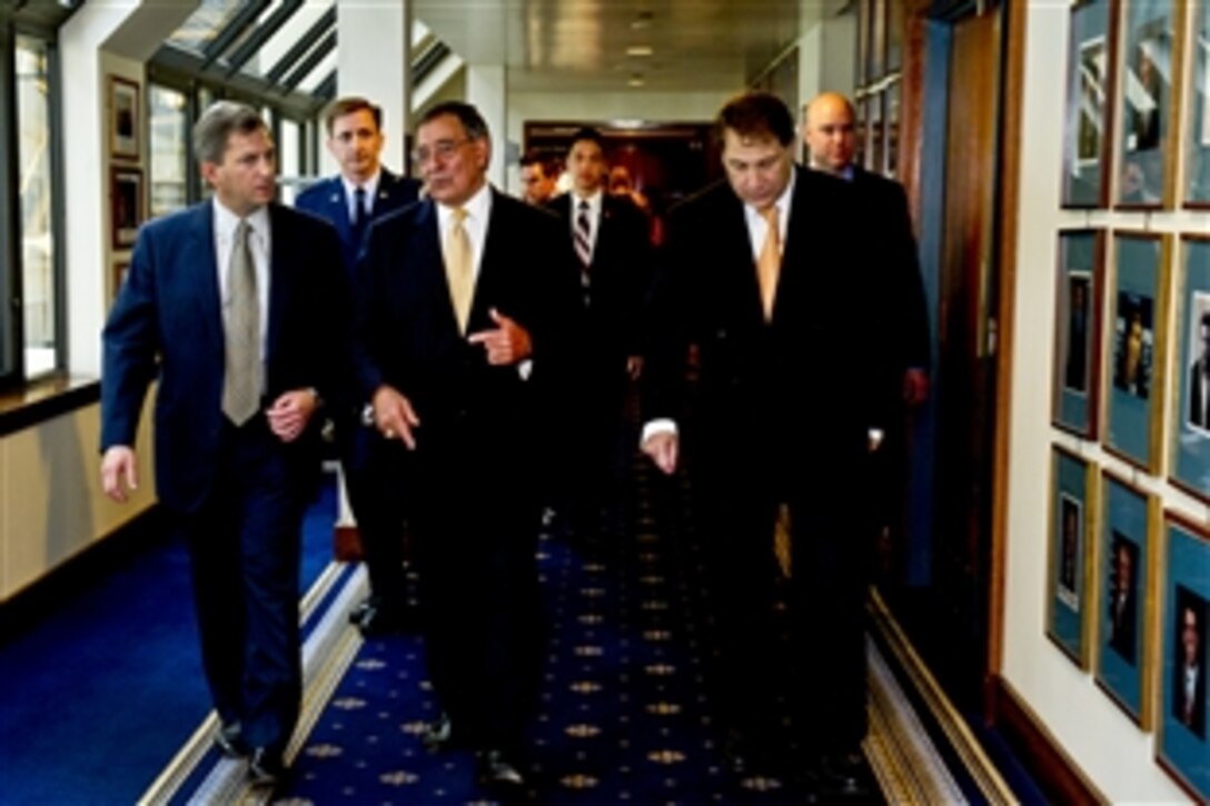 Defense Secretary Leon E. Panetta, center, walks with Scott Bates, left, president of the Center for National Policy, and Peter Kovler, chairman, before the center's awards dinner at the National Press Club in Washington, D.C., June 21, 2012. During the dinner, Panetta received the Edmund S. Muskie Distinguished Public Service Award, which honors the late Muskie for his service in the Navy, as governor of Maine, as U.S. senator and as U.S. secretary of state. 