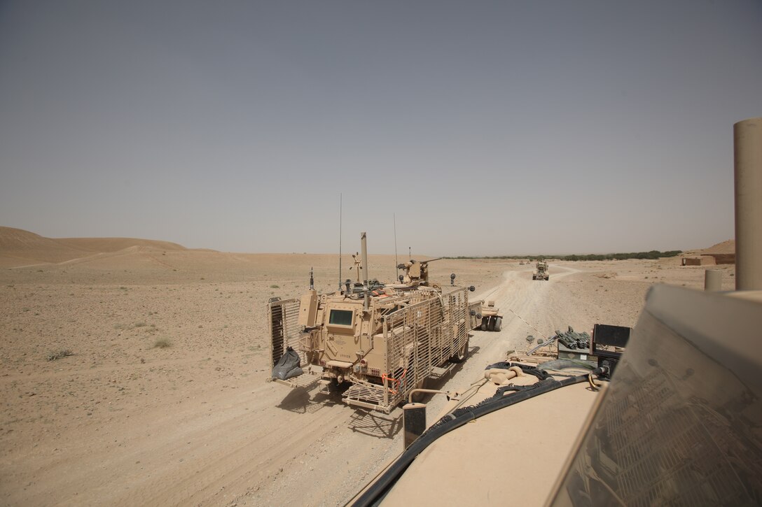 NAHR-E SARAJ, Afghanistan- Vehicles are maneuvered down the road as a part of the route clearance for Operation Jaws in Nahr-e Saraj, Afghanistan June 22, 2012. The ten-day operation brought together Air Force Explosive Ordinance Disposal and Marine Corps and Army route combat engineers to rid the area of roadside bombs.