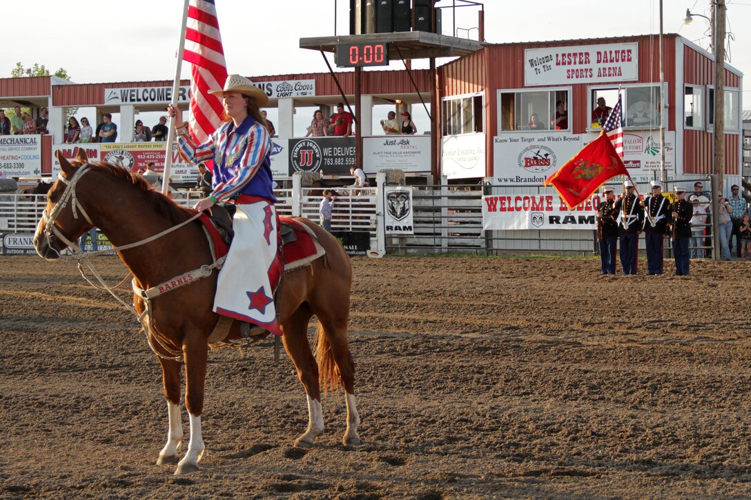 Marines with Recruiting Substation Buffalo perform color guard duties at the 58th Annual Buffalo Championship Rodeo June 23. The three-day event featured calf roping, barrel racing and bull riding. Hundreds of people visited the Marine booth to take the fitness challenge, including Miss Rodeo Minnesota Sabrina Behr.