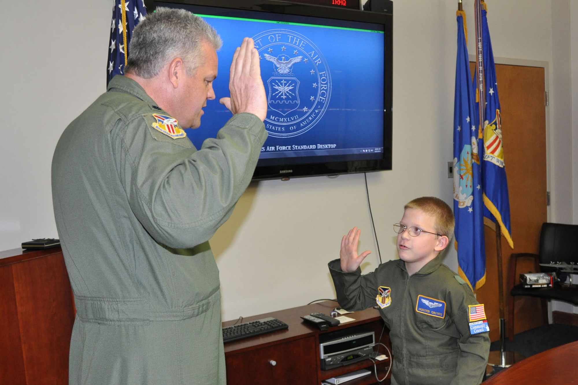 YOUNGSTOWN AIR RESERVE STATION, Ohio -- Air Force Reserve Lt. Col. Don Richey, acting commander of the 910th Operation Group,  administers the oath of office swearing in 10-year-old Hunter Crites of Austintown, Ohio as an honorary second lieutenant here June 22. Hunter was selected by Akron Children's Hospital Mahoning Valley to be honored as a pilot for a day. He is being treated for Cerebral Palsy. Hunter was taxied aboard a C-130 Hercules aircraft and given a special tour of the installation. The 910th Airlift Wing pilot for a day program began in 2000 to help bring a ray of sunshine into the lives of children being treated for chronic or life threatening conditions.