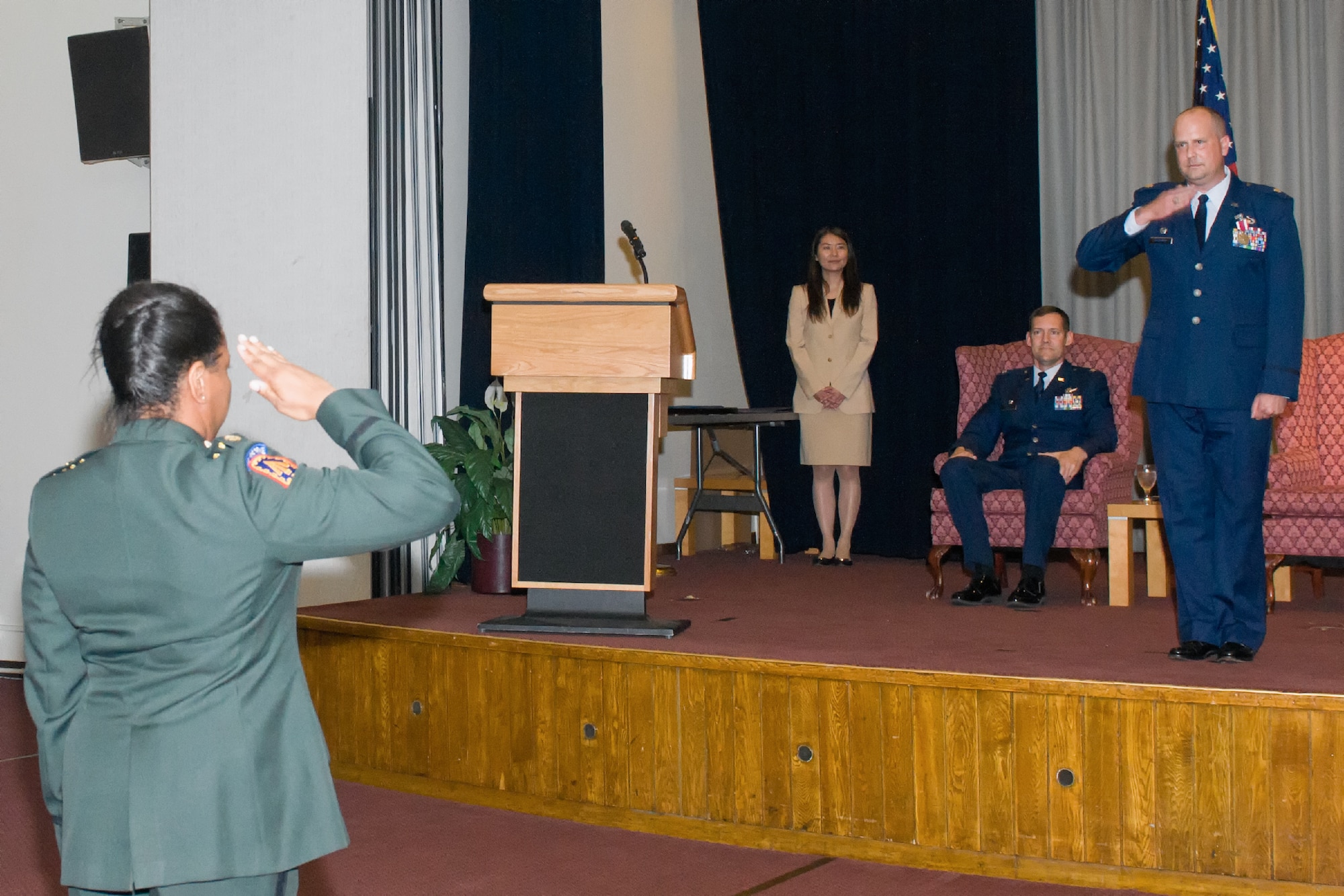 YOKOTA AIR BASE, Japan -- U.S. Army Maj. Lisa Carter, 374th Contracting Squadron army support flight deputy commander, left, presents her final salute to Lt. Col. Michael Hackman as the 374th CONS commander during the change of command ceremony at Yokota Air Base, Japan, on June 22, 2012. Hackman was responsible for providing $1.8 billion in direct contracting support via operational, specialized and research and development contracting to 130,000 U.S. Pacific Command personnel assigned at 35 locations. (U.S. Air Force photo by Osakabe Yasuo)