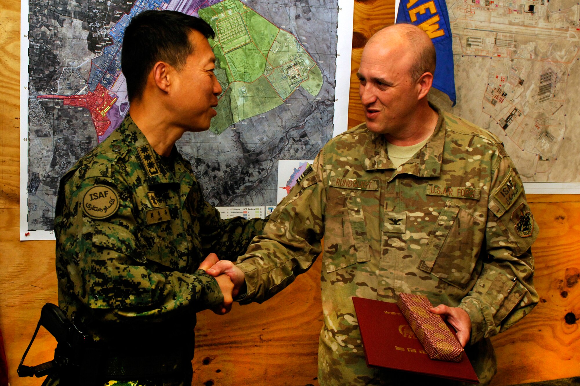 Col. Wankyu Choi, Republic of Korea Provincial Reconstruction Force commander, presents Col. Erik Rundquist, 455th Expeditionary Mission Support Group commander, with the ROK Joint Chiefs of Staff Certificate of Commendation at Bagram Airfield, Afghanistan June 24, 2012. Rundquist was presented the award on behalf of Gen. Jung Seung-jo, Chairman of the ROK JCS, for his group’s assistance in establishing the Korean Provincial Reconstruction Team in Sharikar Province. (U.S. Air Force photo/Staff Sgt. Jeff Nevison)