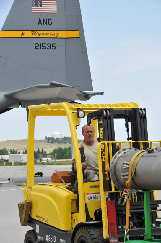 Master Sgt. Kevan Johnson, 153rd Logistics Readiness Squadron, Cheyenne, Wyo., prepares to load a U.S. Forest Service Modular Airborne Firefighting System II onto a Wyoming Air National Guard C-130, June 24, 2012. The Wyoming Air National Guard MAFFS unit has been activated to support the Rocky Mountain area fires, they will base out of Colorado Springs, Colo. (U.S. Air Force photo by Staff Sgt. Natalie Stanley)