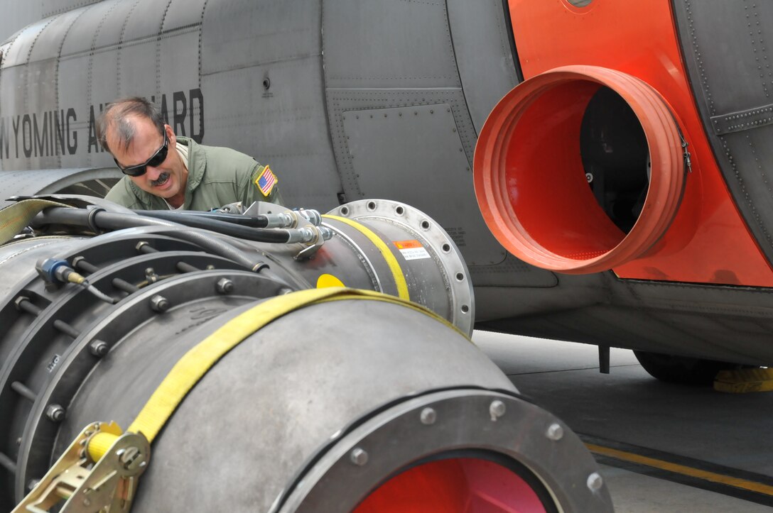 Senior Master Sgt. Jack Goeken, loadmaster, 187th Airlift Squadron, Cheyenne, Wyo., prepares to load a U.S. Forest Service Modular Airborne Firefighting System II nozzle onto a Wyoming Air National Guard C-130, June 24, 2012. The Wyoming Air National Guard MAFFS unit has been activated to support the Rocky Mountain area fires, they will base out of Colorado Springs, Colo. (U.S. Air Force photo by Staff Sgt. Natalie Stanley)
