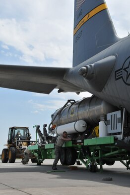 Members of the 153rd Airlift Wing, Cheyenne, Wyo., prepare to load a U.S. Forest Service Modular Airborne Firefighting System II onto a Wyoming Air National Guard C-130, June 24, 2012. The Wyoming Air National Guard MAFFS unit has been activated to support the Rocky Mountain area fires, they will base out of Colorado Springs, Colo. (U.S. Air Force photo by Staff Sgt. Natalie Stanley)