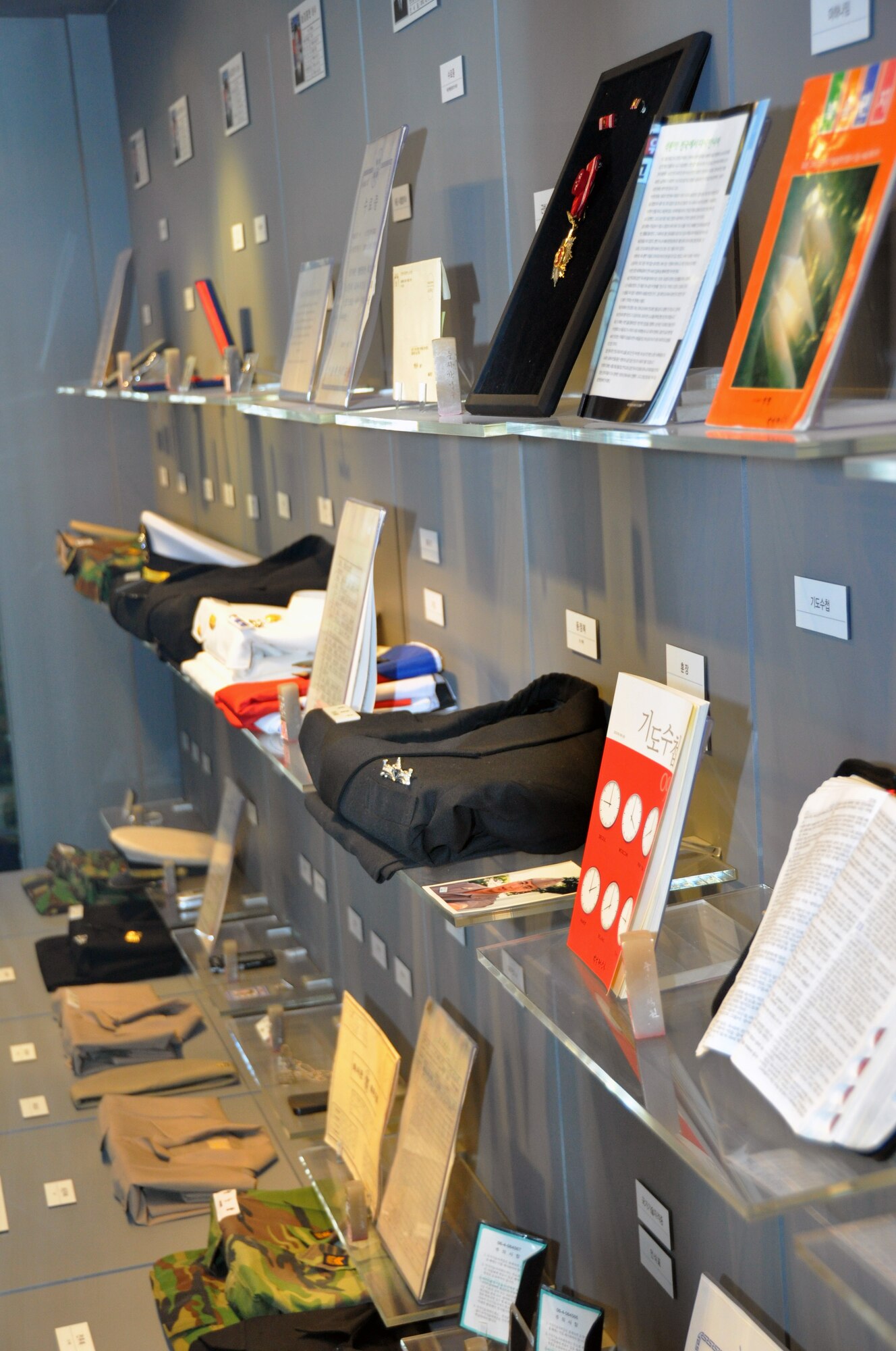 Personal items from crew members killed in the March 26, 2010 attack on the Republic of Korea naval ship, Cheonan, are displayed in the West Sea Protection Hall at Pyeongtaek Naval Station, June 21, 2012. The Cheonan was conducting a routine patrol operation southwest of Baengnyeong-do when it was sunk by to a torpedo attack.  Out of 104 Korean sailors aboard 46 were killed. (U.S. Air Force photo/Senior Airman Michael Battles) 