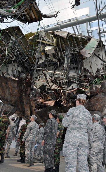 U.S. and Republic of Korea service members view the salvaged wreckage of ROK naval ship, Cheonan, at the ROK Navy 2nd Fleet Command at Pyeongtaek Navy Station, June 21, 2012. Forty-six Korean service members were killed, March 26, 2010, when a North Korean submarine sank the Cheonan with a torpedo. The detonation location was three meters to port from the center of the gas turbine room. The purpose of the tour is for ROK-US service members at Osan AB to acknowledge Korean security situations and strengthen the spirit of defending peace and liberty on the peninsula. (U.S. Air Force photo/Senior Airman Michael Battles) 