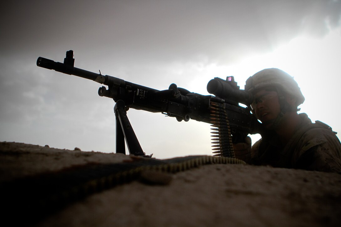 Lance Cpl. Christopher Yudin, a machinegunner with 2nd Battalion, 5th Marines, Regimental Combat Team 6, looks through the sights of his M240 machinegun, May 30, 2012.