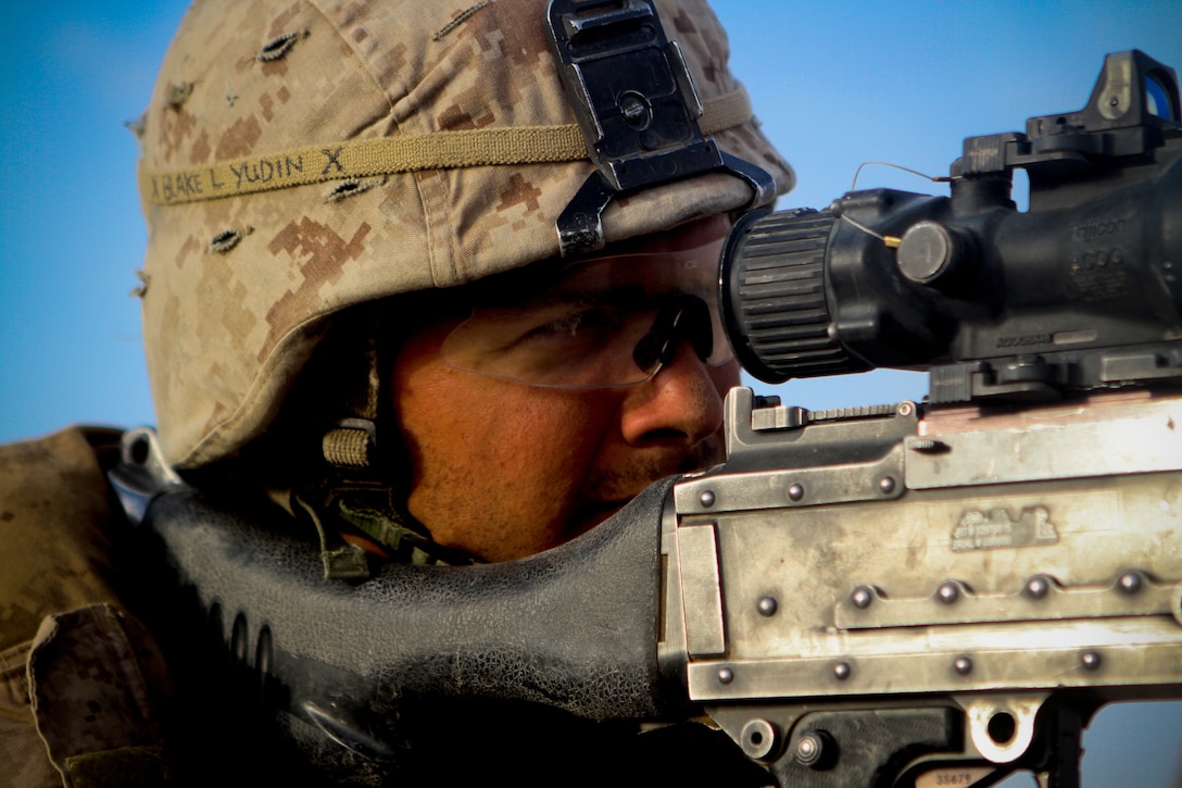 Lance Cpl. Christopher Yudin, a machinegunner with 2nd Battalion, 5th Marines, Regimental Combat Team 6, looks through his scope of his M240 machine gun, May 30, 2012. Yudin, a native of Seattle, plans to apply for citizenship when he returns from his deployment.