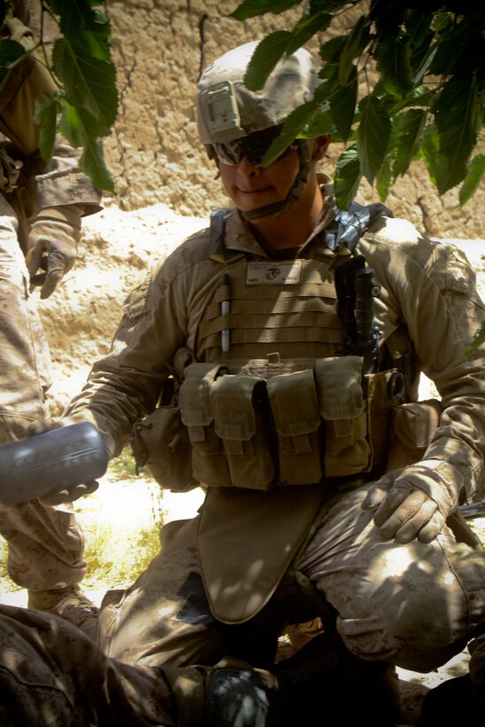 Petty Officer 3rd Class, Norberto Zamora, a hospital corpsman with 2nd Battalion, 5th Marines, Regimental Combat Team 6, prepares a rehydration solution for a Marine, May 28, 2012. Zamora carries extra water when in the field to fight the adverse conditions the Marines face.