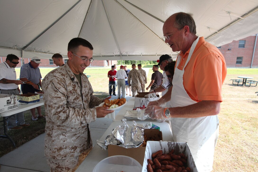 Sgt. Nicolas L. Peterson, a ground radio repairman with 2nd Marines Special Operations Battalion, lined up for food during the Jacksonville-Onslow Chamber of Commerce Military Affairs Committee Fish Fry hosted aboard Stone Bay recently. The committee will host future fish fries at Stone Bay June 20, MCAS New River Sept. 19 and MCB Camp Lejeune’s Courthouse Bay area Oct. 17.  