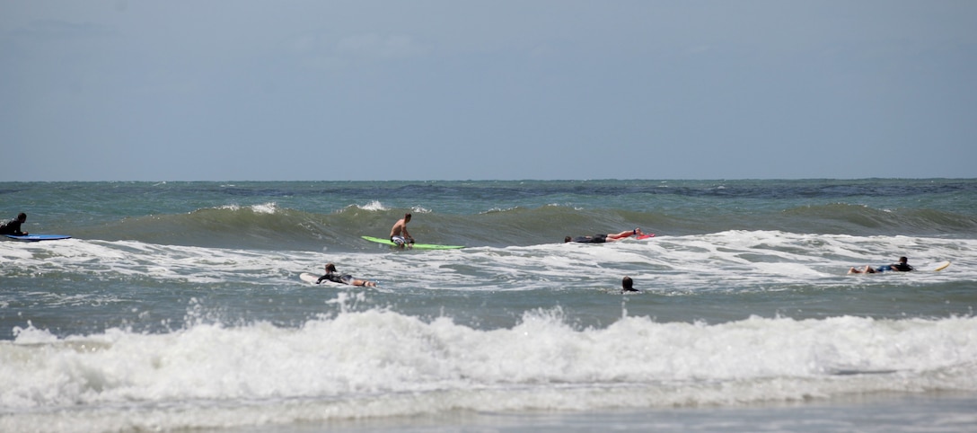 Wa Lu Warriors and their instructors paddle through the waves at Onslow Beach aboard Marine Corps Base Cmap Lejeune, June 15. The Ma Lu Warriors are wounded warriors who enjoy the therapeutic aspects of surfing. 