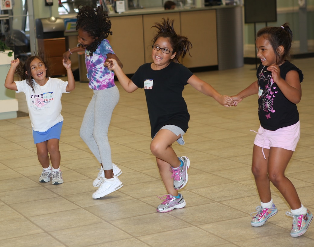 Children jump and dance while participating in Zumbatomic at the Midway Park Community Center , at the housing community aboard Marine Corps Base Camp Lejeune. Zumbatomic gave the children an opportunity to have fun while working out and learning about other cultures. 

