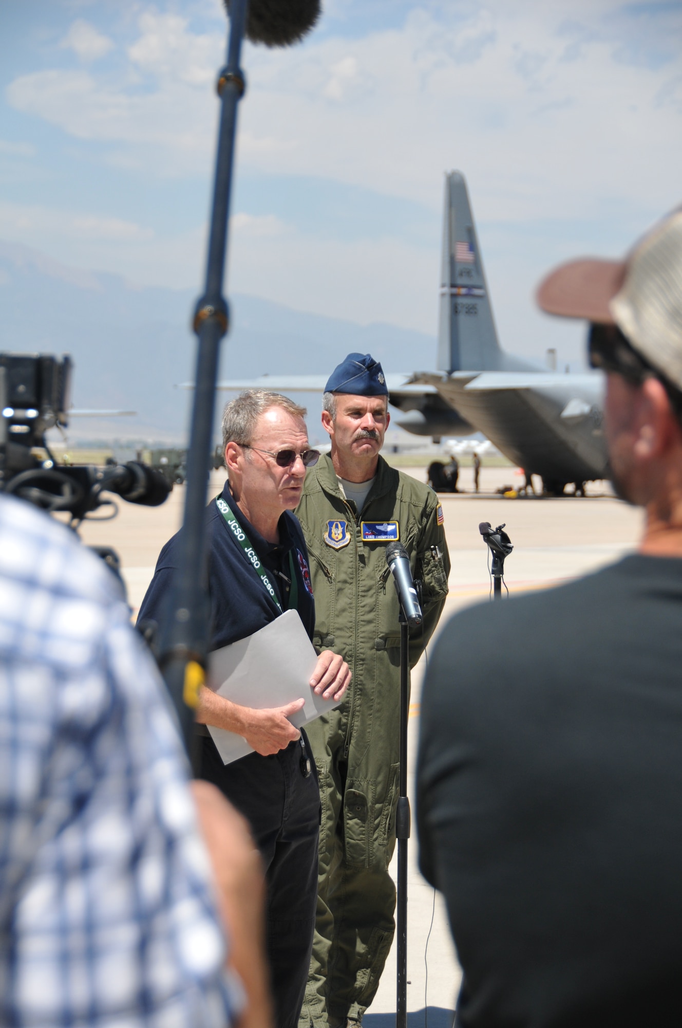 Lt. Col. Luke Thompson, 302nd Airlift Wing chief of aerial firefighting, and Jerry McCann, spokesman for the Rocky Mountain Area Coordination Center, speak with members of the media on the flightline at Peterson Air Force Base, Colo., June 25, 2012. Thompson and McCann addressed questions regarding the activation of the Department of Defense's Modular Airborne Firefighting System capability. (U.S. Air Force photo/Airman 1st Class Nichole Grady)